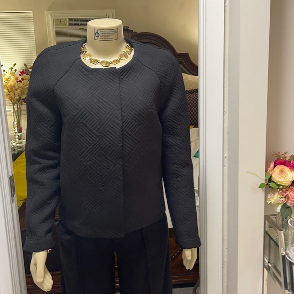 Waist length express jacket with design on it.